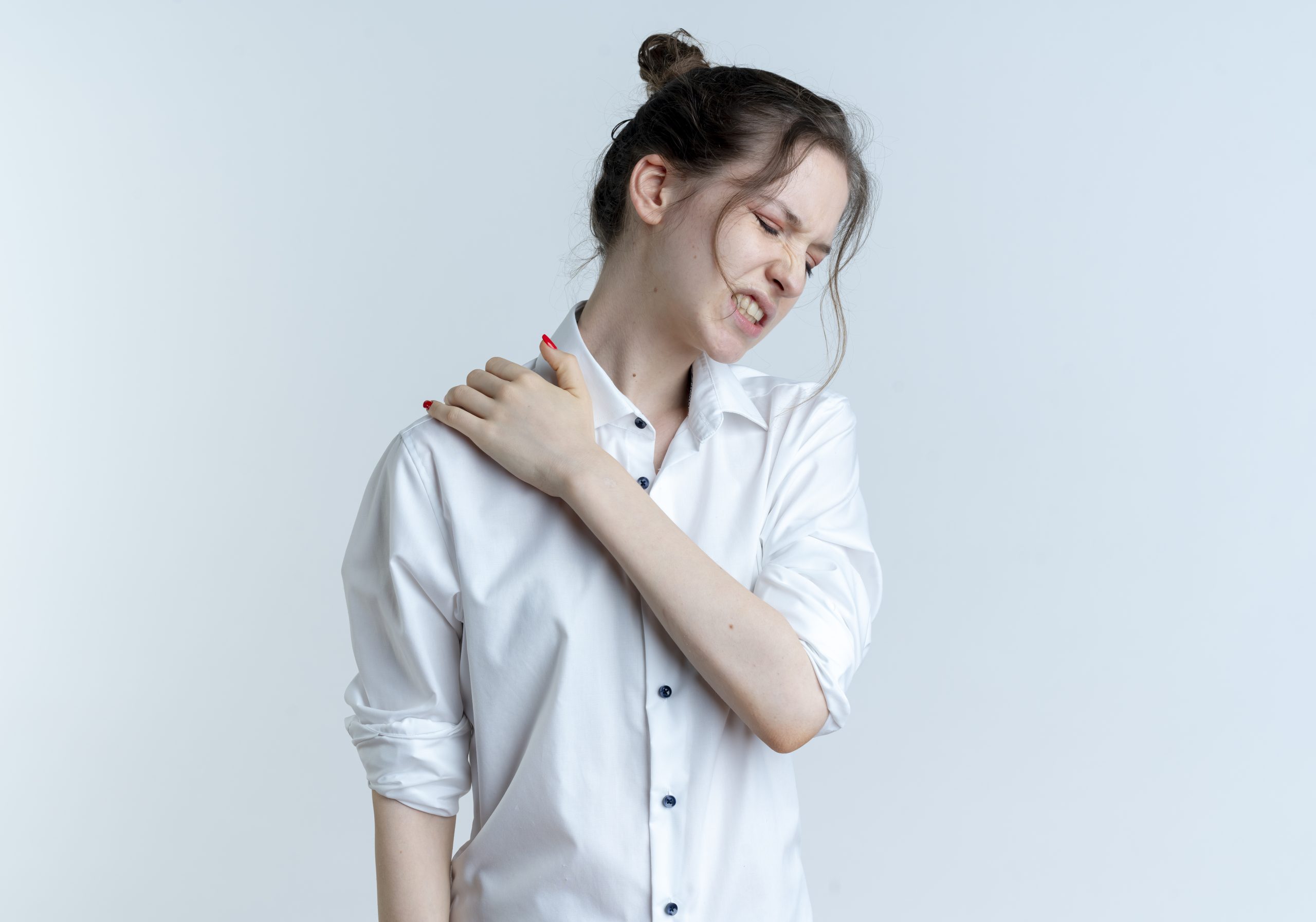 young girl experiencing shoulder pain on a white background